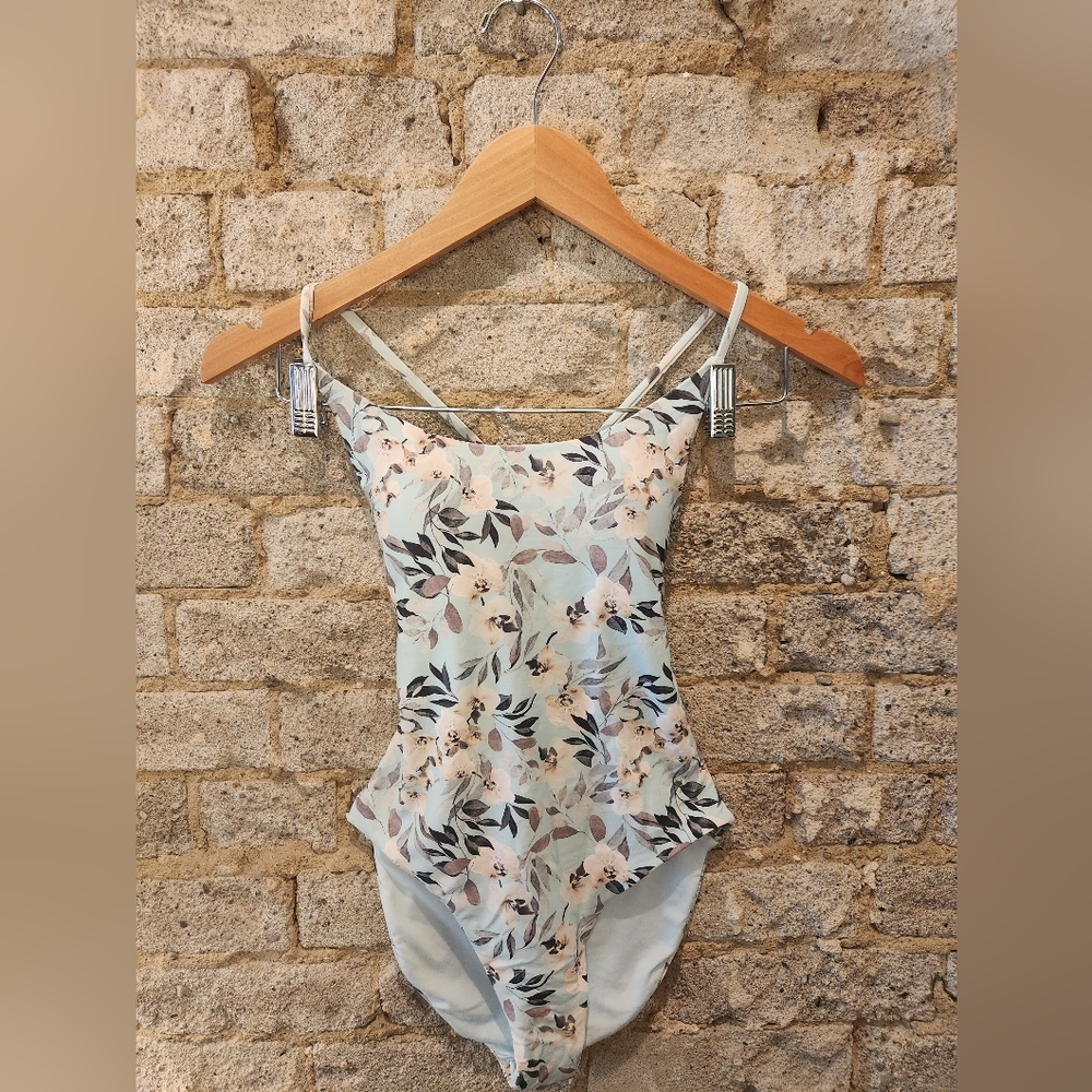 One piece swimsuit. Baby blue, floral print.  Crisscross back and side cut outs